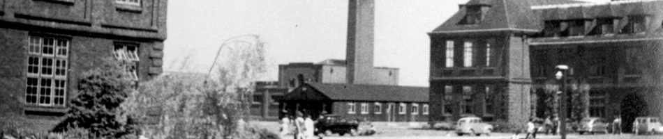 University of Hull buildings, smokestack, parked cars, and people in mid-20th century setting