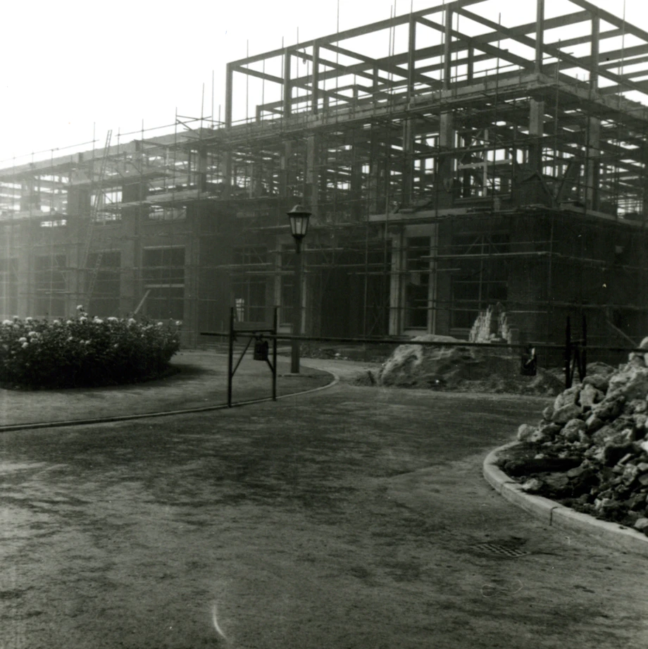 Black and white photo of Brynmor Jones Library construction with scaffolding, curved walkway, streetlamp, and landscaping rocks
