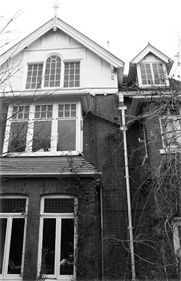 Black and white photo of Larkins flat with large windows.